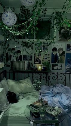 a bed room with a neatly made bed and lots of hanging plants on the wall