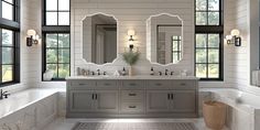 a large bathroom with double sinks, mirrors and bathtub in front of two windows