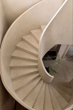 a white spiral staircase in a house