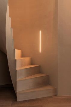 the stairs are made of concrete and have light coming from them on each side,