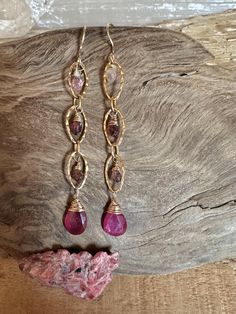 Gold filled dangle earrings with pink tourmaline gemstones Gold Bohemian Earrings With Gemstone Accents, Fine Jewelry Pink Gold Gemstone Earrings, Pink Gold Gemstone Earrings Fine Jewelry, Elegant Gold Tourmaline Earrings, Pink Gold Gemstone Earrings In Fine Jewelry Style, Pink Oval Ruby Earrings, Fine Jewelry Tourmaline In Pink, Gold Tourmaline Drop Earrings, Pink Tourmaline Jewelry With Gemstone Accents