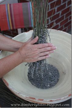 a person is holding some grass in a bowl