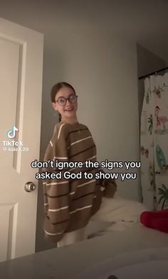 a woman standing in front of a door with a towel on her shoulders and the words don't ignore the signs you asked god to show you