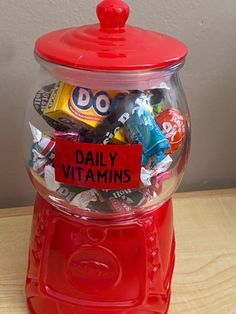 a red gummy machine filled with lots of different types of candy and candies