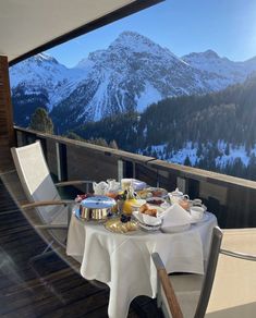 a table with food on top of it in front of a view of the mountains