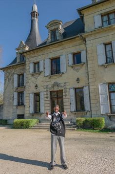 a man standing in front of a large building