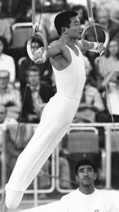 a man performing aerial acrobatics in front of an audience