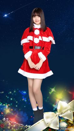 a woman dressed as santa clause standing in front of christmas lights