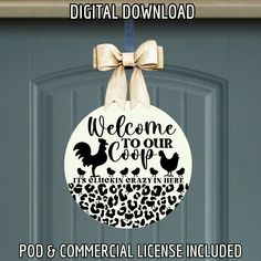 a welcome sign hanging on the front door of a house with an animal print ornament