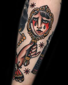 a close up of a person's arm with a tattoo on it and an image of a woman holding a knife