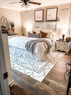 a bed room with a neatly made bed and a ceiling fan