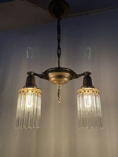 two lights that are hanging from a ceiling