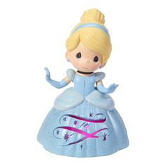 a small figurine with a blue dress and pink ribbon around it's neck