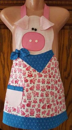 a pink and blue pig apron on a mannequin