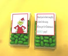 two small plastic containers filled with green candy beans and an elf card on the top