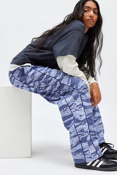 Sporty BDG track pant in a slouchy, relaxed fit. Designed in a water-resistant ripstop woven fabric featuring a mid-rise, elasticated waistband and contrast piping down the legs for a varsity vibe. Exclusively at Urban Outfitters. Features BDG Jess ripstop straight leg track pant Slouchy track pant Water-resistant ripstop woven fabric Midrise elasticated waistband Side pockets Piping down the legs Relaxed, straight-leg fit Full length Pull-on style UO exclusive Content + Care 100% Cotton Machine Athleisure Parachute Pants For Spring Outdoor Activities, Spring Athleisure Parachute Pants For Outdoor, Casual Nylon Sweatpants With Relaxed Fit, Trendy Relaxed Fit Parachute Pants For Outdoor, Relaxed Fit Nylon Cargo Pants With Straight Leg, Relaxed Fit Straight Leg Nylon Cargo Pants, Blue Sporty Cargo Pants With Elastic Waistband, Sporty Blue Cargo Pants With Elastic Waistband, Casual Nylon Sweatpants For Outdoor