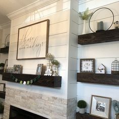 there is a fireplace with some shelves above it and pictures on the mantels