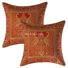 two red and gold pillows with an intricate design on the front, one is made out of