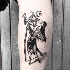 a tattoo on the leg of a woman with a skeleton holding a bow and arrow