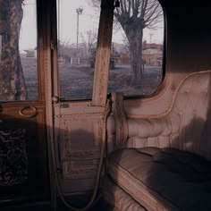 the inside of an old bus with no one in it or someone out on the road