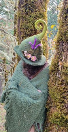 This hand-sculpted hat is made using almost 1lb of sheep's wool, making it extremely durable and able to hold its shape well, perfect for woodland walks.  Inspired by the blossoms of the apple trees growing wild on our land, it features three sprigs of lavender and three apple blossom flowers. We make our felted items using the ancient technique of wet felting. The process begins with raw sheep wool, which we buy locally from small family farms. We then wash dye and card the wool into batts, ready to sculpt and felt into whatever our imaginations dream up. Felted wool is considered to be among the world's oldest known textiles. It is both breathable and water-resistant, able to hold up to 40% of its own weight in water before it begins to feel wet. This makes it an excellent choice for bot Wool Felted Witch Hat, Whimsical Handmade Fall Hats, Whimsical Handmade Felt Hat, Handmade Whimsical Felt Hat For Winter, Whimsical Handmade Felt Costume Hats And Headpieces, Handmade Whimsical Felt Hat, Whimsical Felt Hat With Curved Brim, Whimsical Handmade Wide Brim Felt Hat, Whimsical Wide Brim Handmade Felt Hat