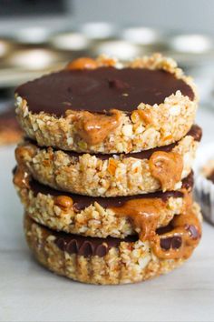 three cookies stacked on top of each other with chocolate and peanut butter in the middle