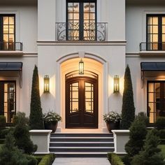 the front entrance to a large white house