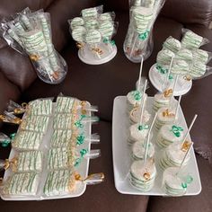 there are many cupcakes on the table with green and white frosted icing