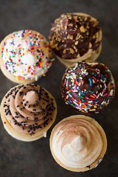 four different types of donuts with sprinkles and chocolate frosting on them