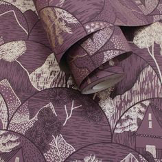 a purple wallpaper with trees and houses on it is next to a roll of tape