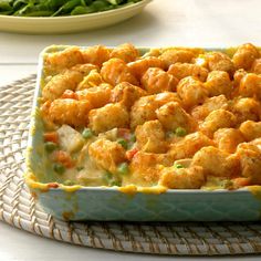 a casserole dish filled with tater tots and vegetables on a table