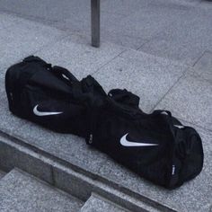 a black bag sitting on the ground next to stairs