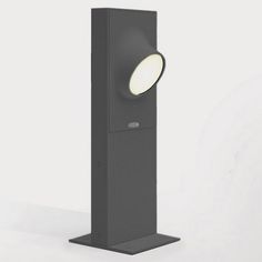 a tall black speaker with a light on it's side