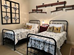 two beds in a room with metal frames