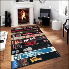 a living room with a fire place and various movie posters on the floor in front of it