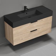 a bathroom vanity with a black counter top