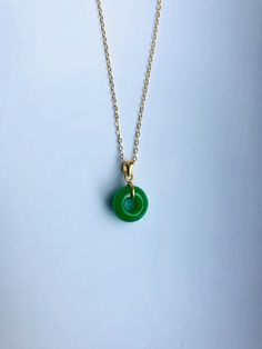 A piece of charming & elegant dark green jade necklace, which is made with genuine 100% natural real green jade donut and 18k gold plated necklace. A great combination of modernness and vintages. The simple and elegant design adds a spark to your daily wear or a bit of charm for your date night. Perfect as a gift for your loved ones or just treat yourself. Some Highlights of this dark green genuine jade circle pendant are: ＊High-quality Material Only 100% natural Chinese green round jade pai Jade Donut Necklace, Minimalist Jade Round Pendant Necklace, Green Jade Necklaces For May Birthstone, Green Minimalist Pendant Necklace, Minimalist Green Pendant Necklace, Minimalist Green Necklace For May Birthstone, Minimalist Jade Round Pendant Jewelry, Minimalist Jade Necklace Gift, Green Round Minimalist Jewelry