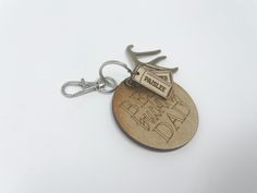 a wooden keychain with the words happy father's day written on it