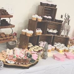 a table topped with lots of cakes and cupcakes