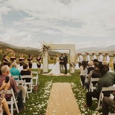 an outdoor wedding ceremony in the mountains