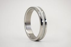 a wedding ring made from stainless steel on a white background, with no people around it