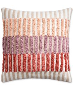 a multicolored pillow with fringes on it