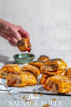 Mini sausage rolls on a white background with a hand dipping a sausage roll into tomato sauce. Mini Sausage Rolls, Puff Pastry Crust, Sausage Roll, Festive Appetizers, Appetizers For A Crowd, Best Christmas Recipes, Delicious Appetizer Recipes, Flaky Pastry, Sausage And Egg