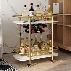 a bar cart with bottles and glasses on it