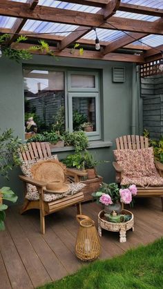 an outdoor patio with wooden furniture and potted plants on the deck area, along with greenery