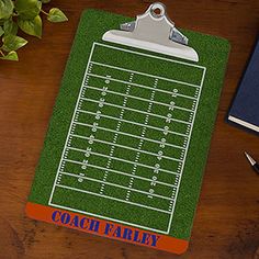 a clipboard with a football field on it