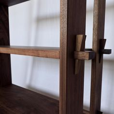 a wooden shelf with two shelves on each side