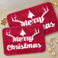 two bath mats with merry christmas designs on them