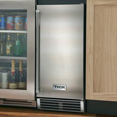 a stainless steel refrigerator with its door open and beer bottles in the bottom drawer,