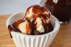 an ice cream sundae with chocolate drizzled on top